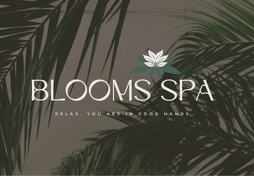 Blooms Spa logo over palm leaves